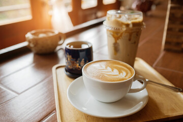 hot latte art coffee on wood table, relax time
