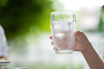 closeup hand drinking fresh water, healthcare concept