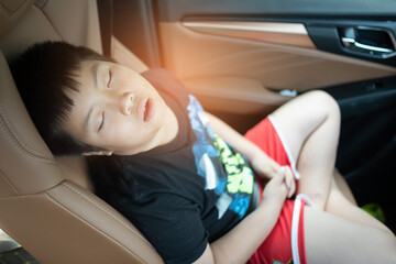 Obraz na płótnie Canvas kid sleep on car, child feel sick, sleep on car seat