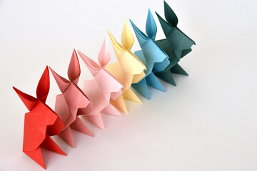 Origami paper rabbits on white background.