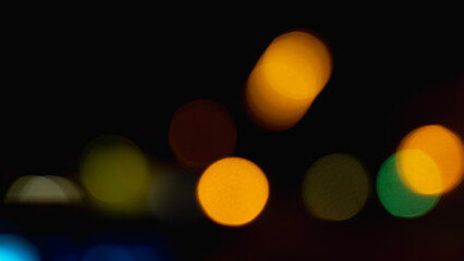 Beautiful colorful bokeh background.Long exposure light painting, curvy lines of different color in vibrant neon on black background. Orange bokeh background. Modern background. Abstract.