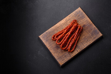 Delicious thin smoked meat sausages with spices and herbs