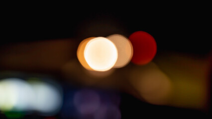 Beautiful colorful bokeh background.Long exposure light painting, curvy lines of different color in vibrant neon on black background. Red,orange bokeh background. Modern background. Abstract.