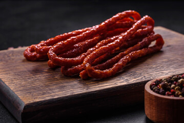 Delicious thin smoked meat sausages with spices and herbs