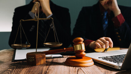 Business and lawyers discussing contract papers with brass scale on desk in office. Law, legal...