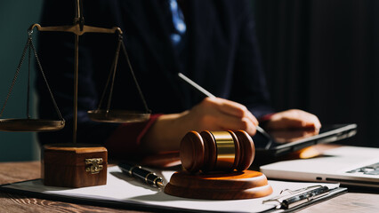 Business and lawyers discussing contract papers with brass scale on desk in office. Law, legal services, advice, justice and law concept picture with film grain effect