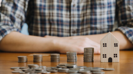 businessman holding coins putting in glass with using calculator to calculate concept saving money for finance accounting, Business, finance, investment, Financial planning.