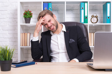 overworked stressed businessman has headache. stressed businessman has headache isolated on white