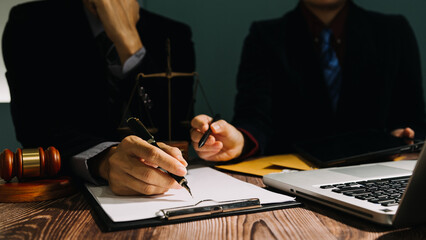 Business and lawyers discussing contract papers with brass scale on desk in office. Law, legal...