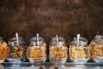 Jars with sweet ingredients for crepes.