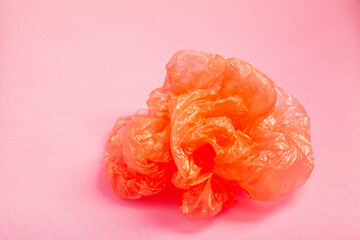 orange plastic bag on pink background