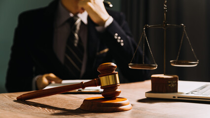 Business and lawyers discussing contract papers with brass scale on desk in office. Law, legal...