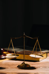 Business and lawyers discussing contract papers with brass scale on desk in office. Law, legal services, advice, justice and law concept picture with film grain effect