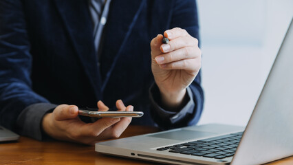 Obraz premium Asian colleagues man and woman discussing and working with laptop computer on office desk in the office