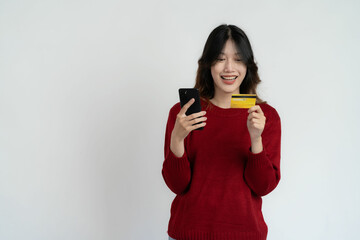 Asian woman holding smartphone and credit card on white background, name concept of online and paying
