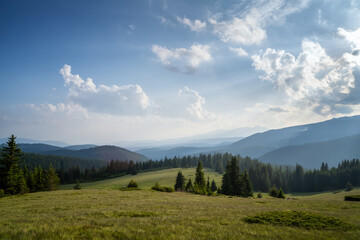 Fototapeta na wymiar Amazing panoramic view with beautiful clouds over tree-covered mountain slopes, Rhodope mountains in Bulgaria