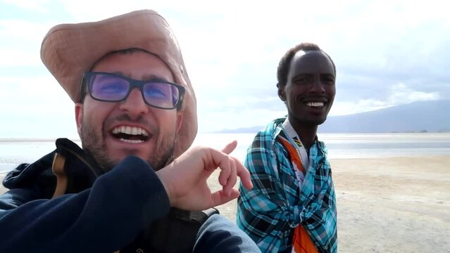 Close up portrait of excited man talking with a Masai about Rift Valley, Vlog