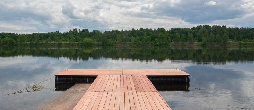 wooden pontoon footbridge at summer.
