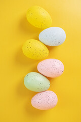 multicolored easter eggs on a yellow background, easter card, happy easter