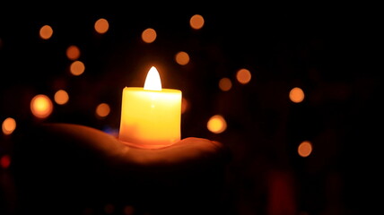 Candles glowing against dark background closeup