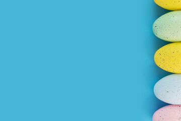 easter background, multicolored easter eggs on blue, easter card, happy easter, copy space