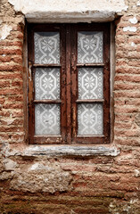 old window in aged brickwall