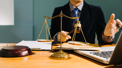 Business and lawyers discussing contract papers with brass scale on desk in office. Law, legal...