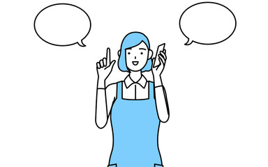 電話をしながら指さしをするエプロンを着た女性