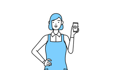 仕事でスマホを使うエプロンを着た女性