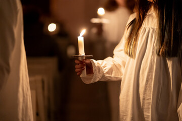People handling candles in the hands. Christmas and lucia holidays - obrazy, fototapety, plakaty
