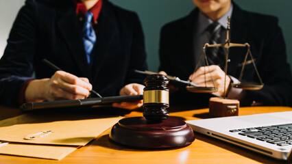 Business and lawyers discussing contract papers with brass scale on desk in office. Law, legal...