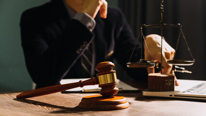 Business and lawyers discussing contract papers with brass scale on desk in office. Law, legal services, advice, justice and law concept picture with film grain effect
