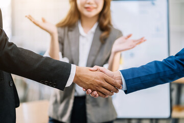 Businessmen shake hands after agreeing to start a new project successfully.