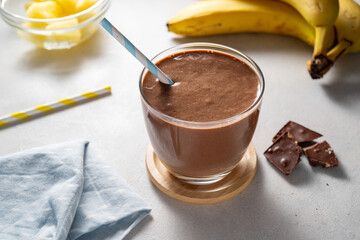 Protein chocolate shake with banana, protein powder and cocoa. Healthy fitness drink.