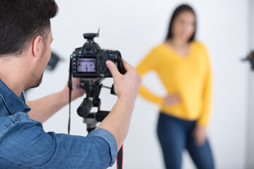 beautiful young model posing for professional photographer in studio