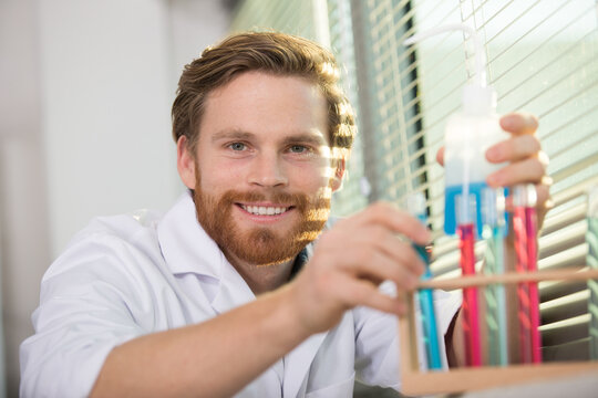 scientist working with test tubes in a rack