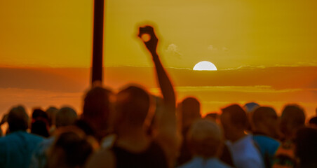 People take pictures of the famous sunset at Mallory Square, Key West.