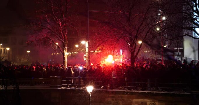 Red smoke grenade fog effect over thousands of people on street celebration of French supporters after France wins the FIFA World Cup semifinal match against Morocco. France qualified to the final, wh