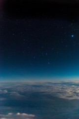 Stars and iluminated city from plane at night