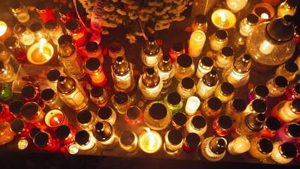 Candle Flames on Cemetery an Night, All Saint's Day , Death Holiday Lantern, 1 November Candles, Fallen Leaves, Blurred Background