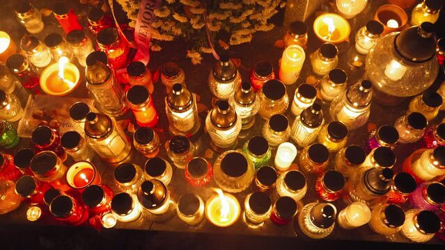 Candle Flames on Cemetery an Night, All Saint's Day , Death Holiday Lantern, 1 November Candles, Fallen Leaves, Blurred Background