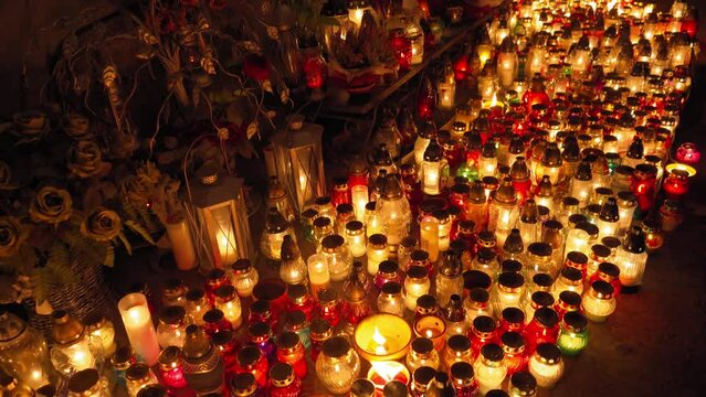 Candle Flames on Cemetery an Night, All Saint's Day , Death Holiday Lantern, 1 November Candles, Fallen Leaves, Blurred Background
