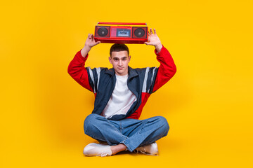 A handsome guy in the style of the 90s with a boombox on a yellow background