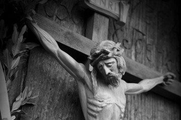 Holy cross with crucified Jesus Christ. Ancient wooden statue.