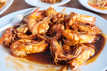 Shrimp dish with spicy sauce on a white plate