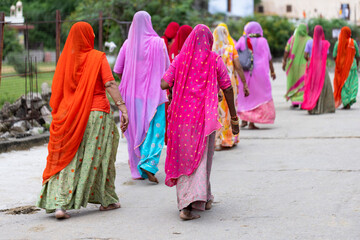 A bunch of barefoot indian women entering Galta ji temple. Jaipur, Rajasthan (India).