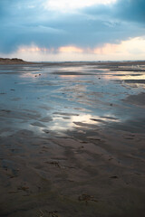 Wadden sea at low tide, North sea beach landscape, coast on Romo island in Denmark at sunset, vacation und lifestyle
