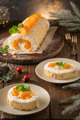 Meringue roll cake with cream, tangerine.
