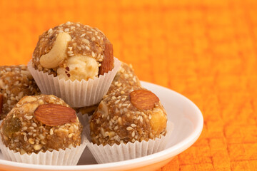 Indian Winter Delicacy White Ball Shaped Tilgul Laddu Or Safed Til Ki Laddo Is Made Of Roasted Sesame Seed, Jaggery, Gur, Gud, Makhana, Kaju, Badam Is Enjoyed In Winter On Makar Sankranti and Lohri