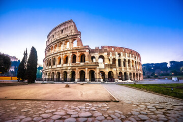 Naklejka premium Rome. Empty Colosseum square in Rome dawn view, the most famous landmark of eternal city